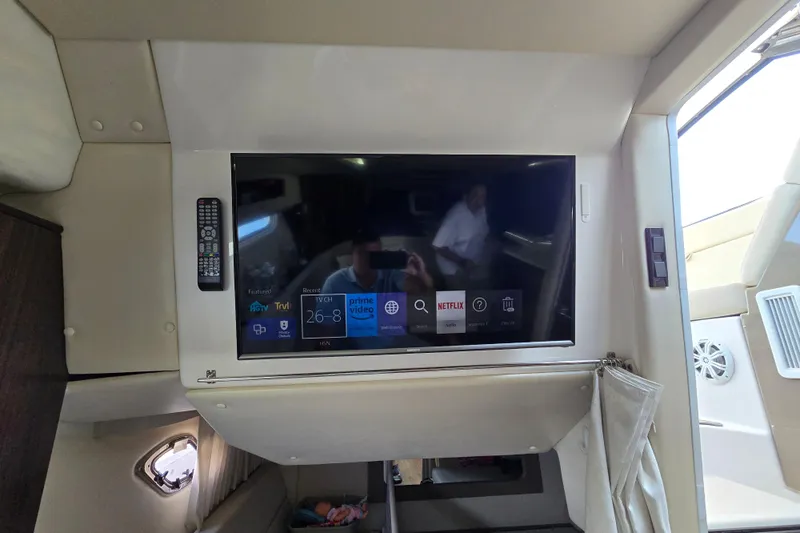  Yacht Photos Pics 2018 Regal 35 Sport Coupe interior with mounted TV displaying streaming apps.