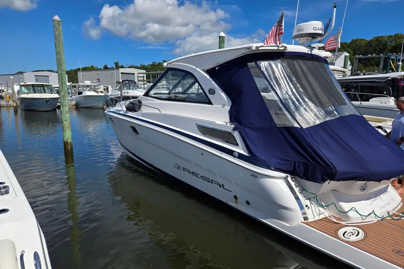  Yacht Photos Pics 2018 Regal 35 Sport Coupe docked at marina under blue sky.