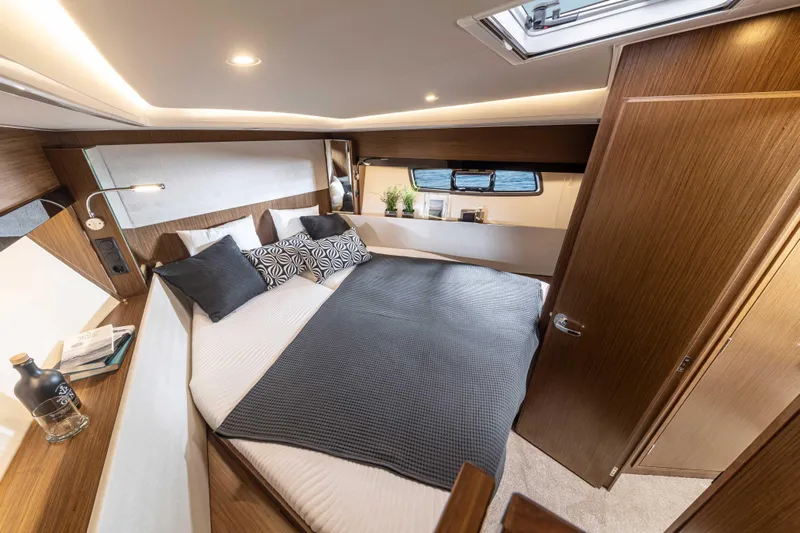 Inventory Clearance Yacht Photos Pics Luxurious bedroom interior of 2023 Bavaria SR41 COUPE yacht with modern design and cozy bedding.