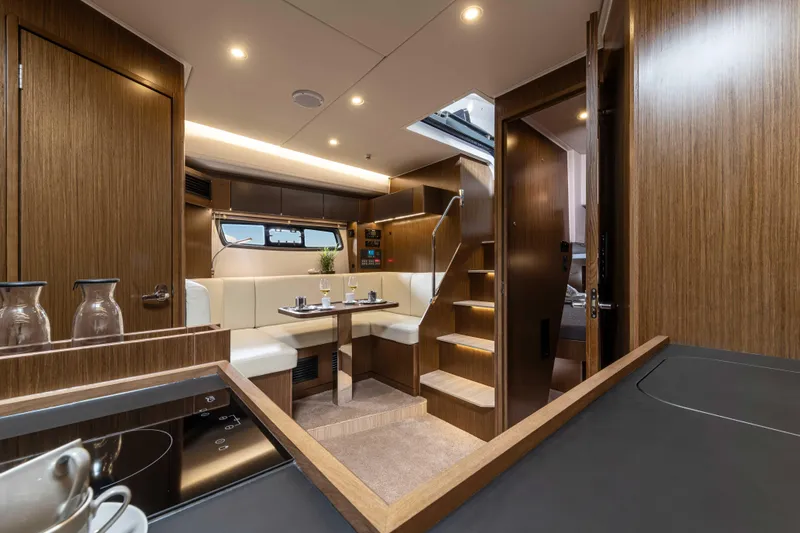 Inventory Clearance Yacht Photos Pics Luxurious interior of 2023 Bavaria SR41 COUPE yacht with modern wood finish.