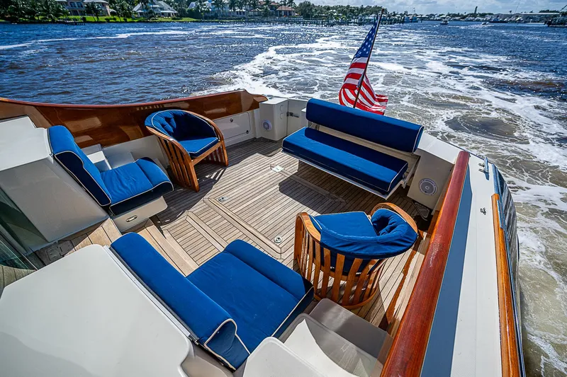 Hooligan VI Yacht Photos Pics Hinckley Talaria 55 MY 2005 yacht deck with blue seating and American flag.