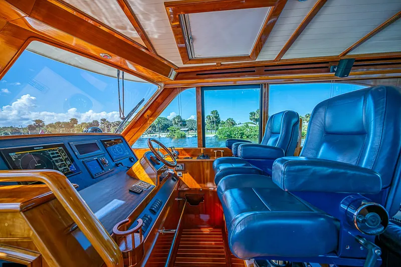 Hooligan VI Yacht Photos Pics 2005 Hinckley Talaria 55 MY helm with blue leather seats and panoramic windows.