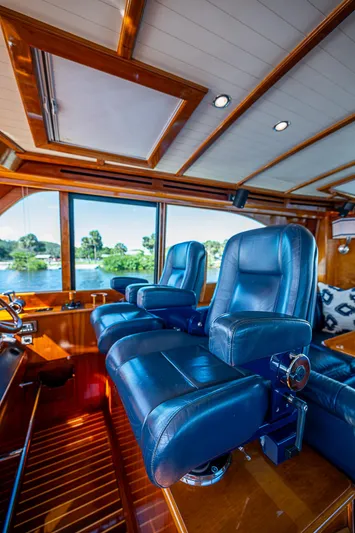 Hooligan VI Yacht Photos Pics Luxurious interior of 2005 Hinckley Talaria 55 MY yacht with plush blue seating.