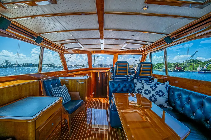 Hooligan VI Yacht Photos Pics Luxurious interior of 2005 Hinckley Talaria 55 MY yacht with polished wood and leather seating.