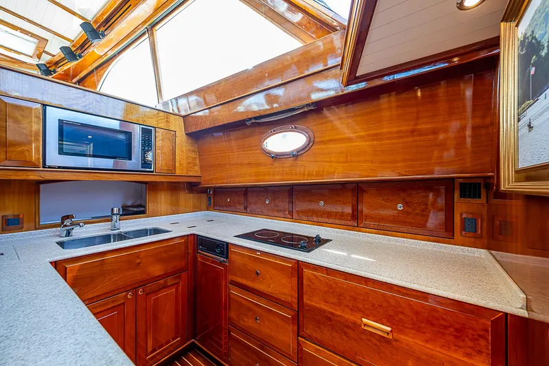 Hooligan VI Yacht Photos Pics Luxurious wooden kitchen interior of 2005 Hinckley Talaria 55 MY yacht.