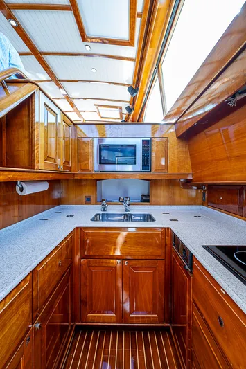 Hooligan VI Yacht Photos Pics Luxurious 2005 Hinckley Talaria 55 MY yacht kitchen with wood cabinetry and modern appliances.