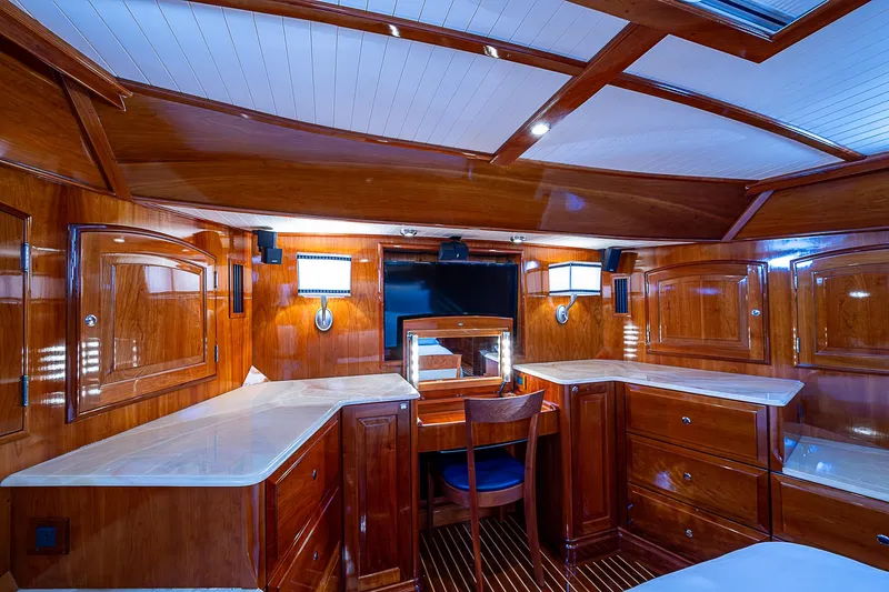 Hooligan VI Yacht Photos Pics Luxurious wooden interior of 2005 Hinckley Talaria 55 MY yacht cabin with desk and lighting.