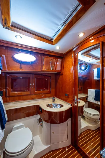 Hooligan VI Yacht Photos Pics Luxurious 2005 Hinckley Talaria 55 MY yacht bathroom with wood accents and modern fixtures.