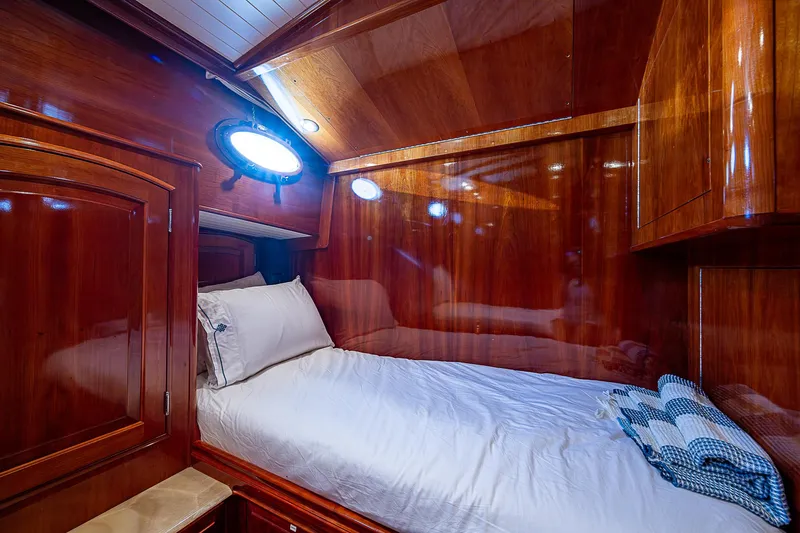 Hooligan VI Yacht Photos Pics Luxurious cabin interior of 2005 Hinckley Talaria 55 MY yacht with polished wood finish.