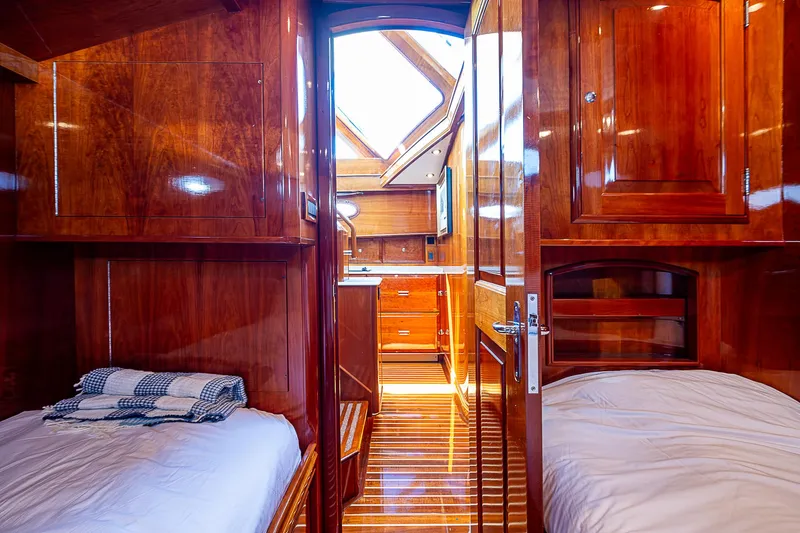 Hooligan VI Yacht Photos Pics Luxurious wooden interior of 2005 Hinckley Talaria 55 MY yacht cabin with twin beds.