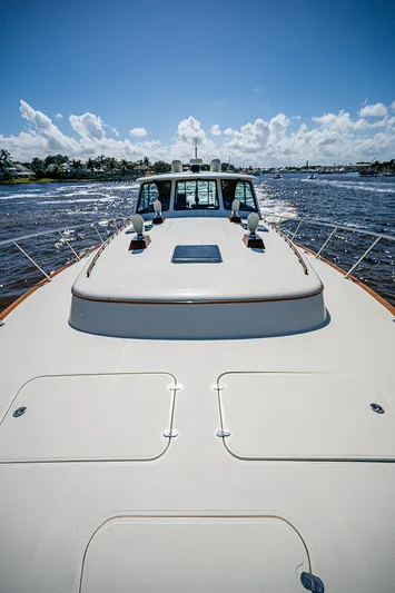 Hooligan VI Yacht Photos Pics Hinckley Talaria 55 MY 2005 yacht cruising on open water under a clear blue sky.