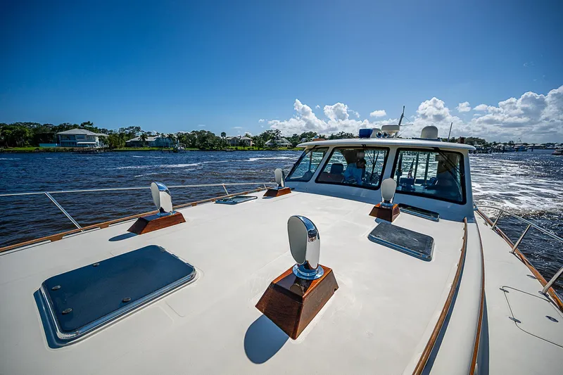 Hooligan VI Yacht Photos Pics Hinckley Talaria 55 MY 2005 yacht cruising on a sunny day, showcasing sleek design and craftsmanship.