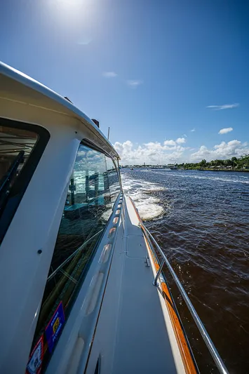 Hooligan VI Yacht Photos Pics Hinckley Talaria 55 MY 2005 cruising on a sunny day, side view of the yacht.