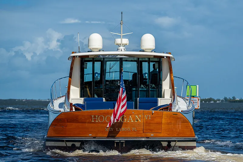 Hooligan VI Yacht Photos Pics Hinckley Talaria 55 MY 2005 yacht on water, rear view with American flag.