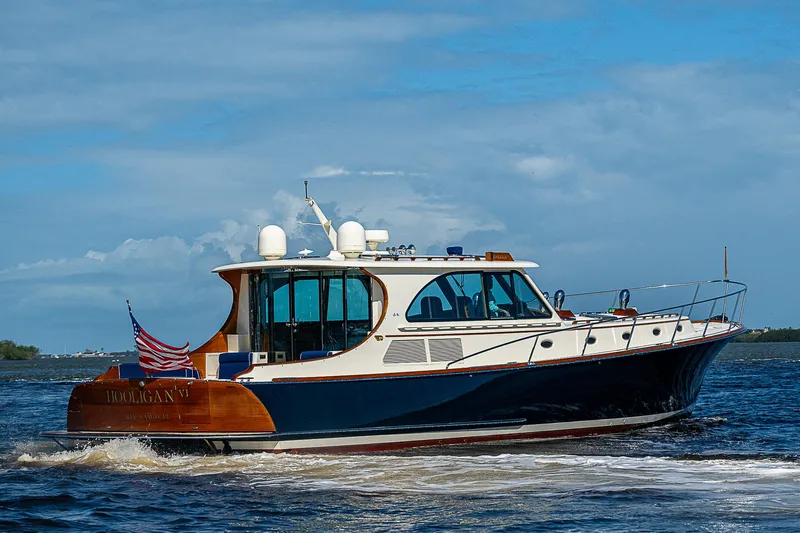 Hooligan VI Yacht Photos Pics 2005 Hinckley Talaria 55 MY yacht cruising on open water under a clear blue sky.