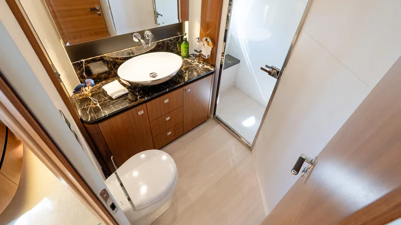 Just Joanne Yacht Photos Pics Luxurious bathroom on 2019 Absolute NAVETTA 58 yacht with elegant fixtures and marble countertop.
