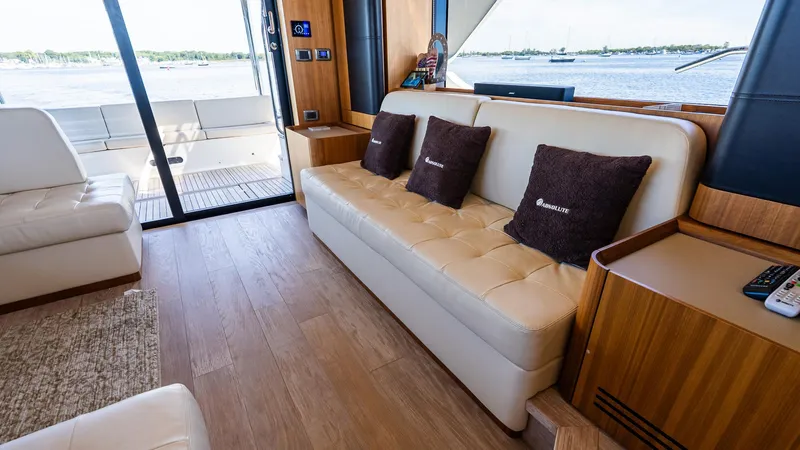 Just Joanne Yacht Photos Pics Luxurious interior of 2019 Absolute NAVETTA 58 yacht with plush seating and scenic views.