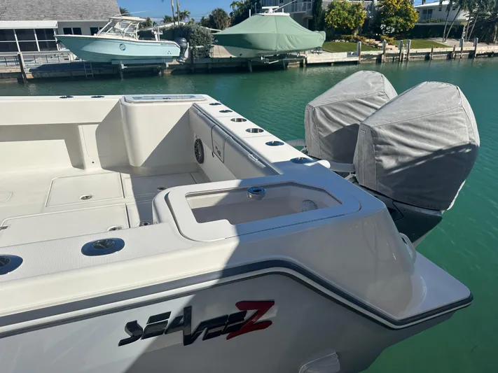  Yacht Photos Pics 2024 SeaVee 322z boat with dual covered engines docked in a marina.