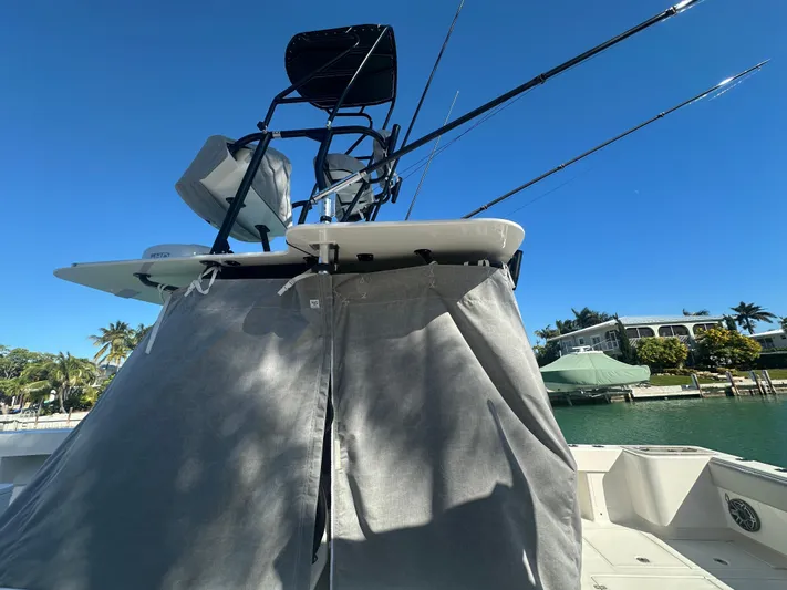  Yacht Photos Pics 2024 SeaVee 322z boat with fishing rods, docked under clear blue sky.
