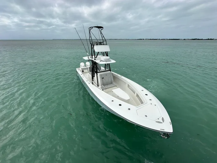  Yacht Photos Pics 2024 SeaVee 322z boat on calm turquoise water under cloudy sky.