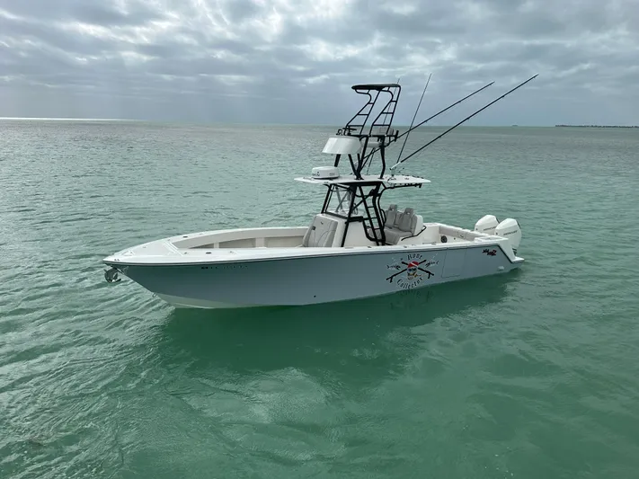  Yacht Photos Pics 2024 SeaVee 322z boat on calm ocean waters under cloudy skies.