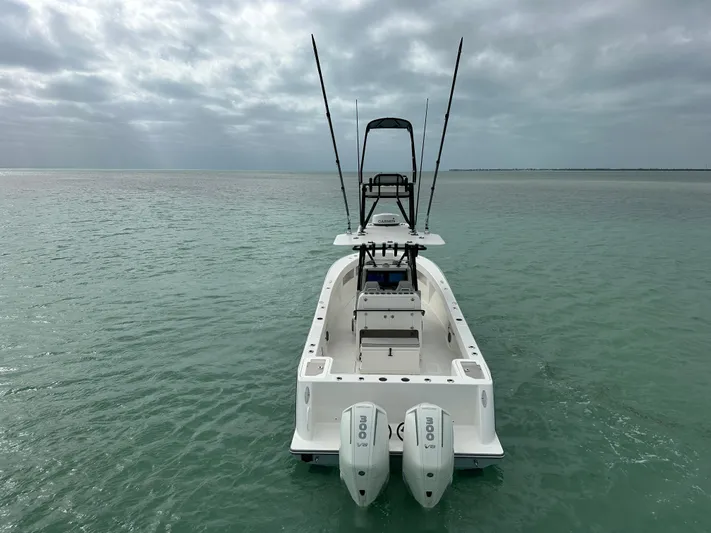  Yacht Photos Pics 2024 SeaVee 322z boat with dual engines on calm water under cloudy sky.