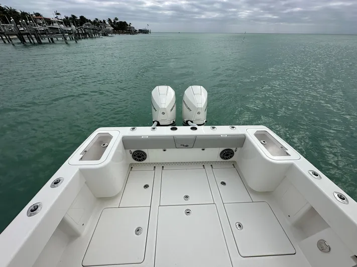  Yacht Photos Pics 2024 SeaVee 322z boat deck with twin engines on calm water.