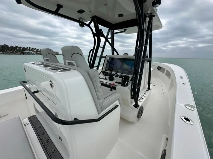  Yacht Photos Pics 2024 SeaVee 322z boat interior with helm and seating, on calm waters.