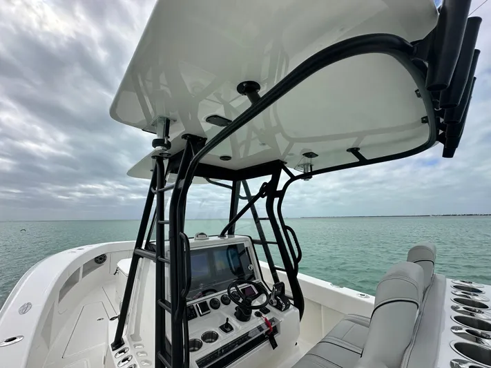  Yacht Photos Pics 2024 SeaVee 322z boat with sleek console and seating on calm water.