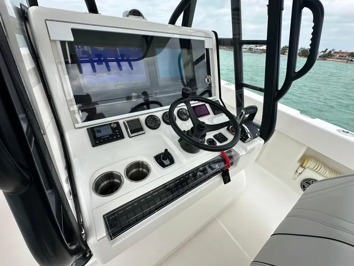  Yacht Photos Pics 2024 SeaVee 322z boat console with steering wheel and navigation displays.