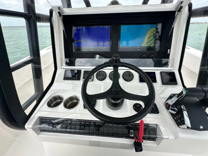  Yacht Photos Pics 2024 SeaVee 322z boat dashboard with steering wheel and navigation screens.