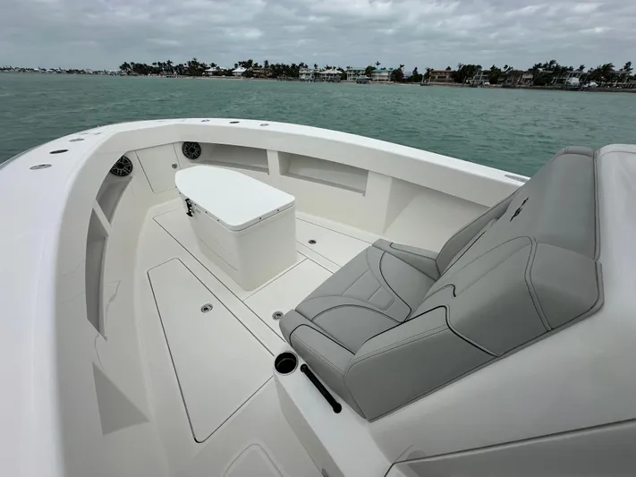  Yacht Photos Pics 2024 SeaVee 322z boat interior with seating and storage, on calm water.