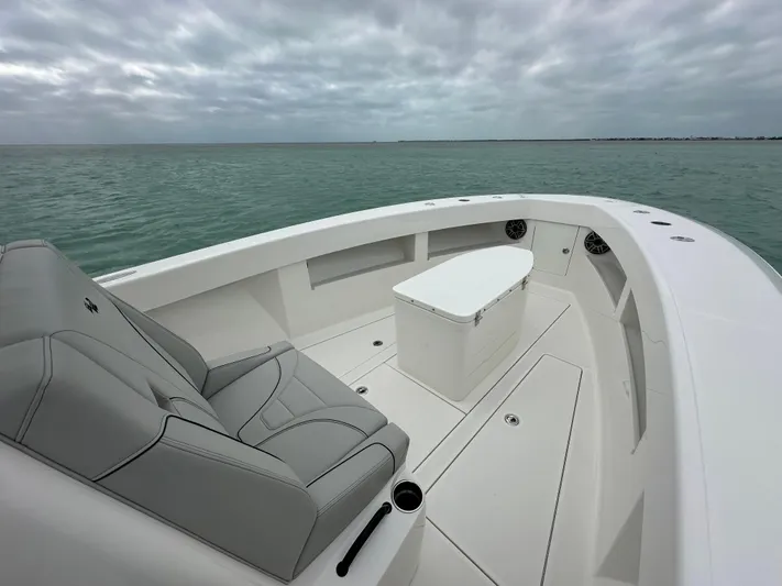  Yacht Photos Pics 2024 SeaVee 322z boat with sleek seating and storage on calm waters.