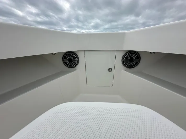  Yacht Photos Pics 2024 SeaVee 322z boat interior with speakers and storage compartment under cloudy sky.