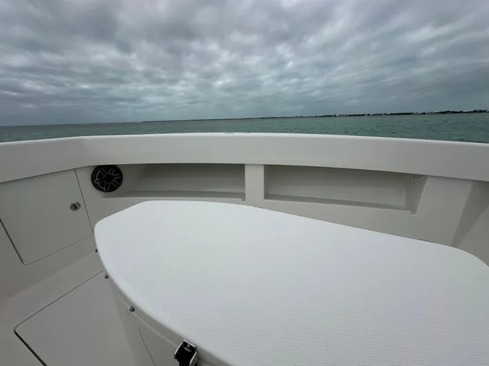  Yacht Photos Pics 2024 SeaVee 322z boat deck with ocean view under cloudy sky.