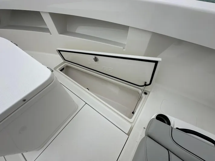  Yacht Photos Pics 2024 SeaVee 322z boat storage compartment with open hatch and seating area.