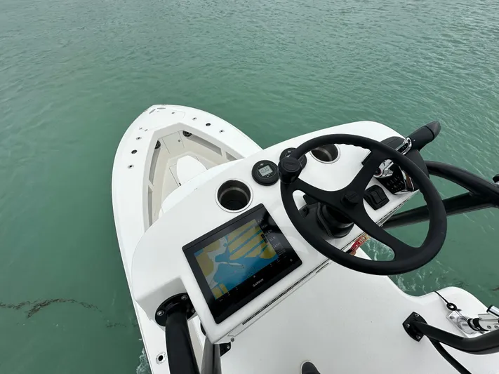  Yacht Photos Pics 2024 SeaVee 322z boat helm with navigation screen on calm water.