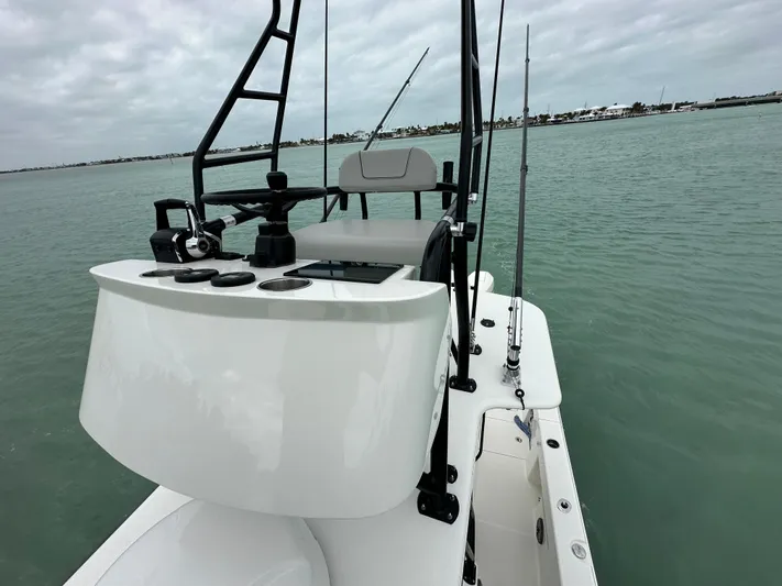  Yacht Photos Pics 2024 SeaVee 322z boat on calm water, featuring a sleek helm and fishing rods.