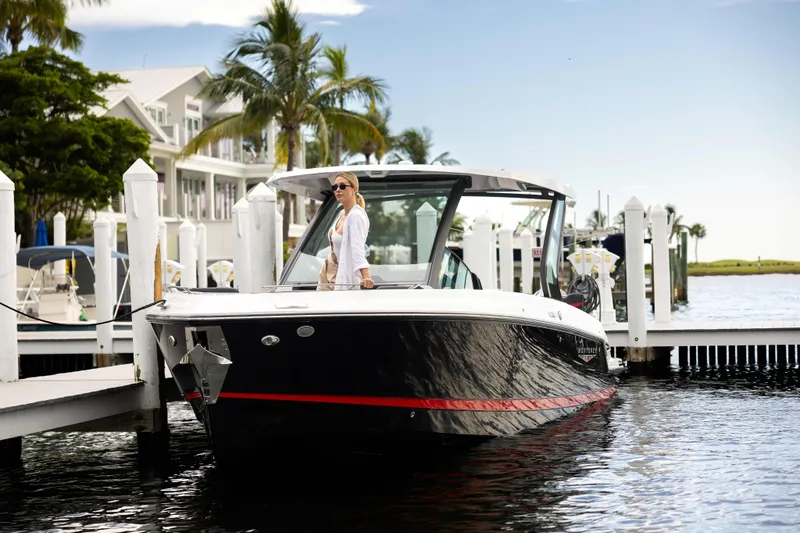  Yacht Photos Pics 2026 Monterey Elite 30 OB boat docked at marina with palm trees and waterfront homes.