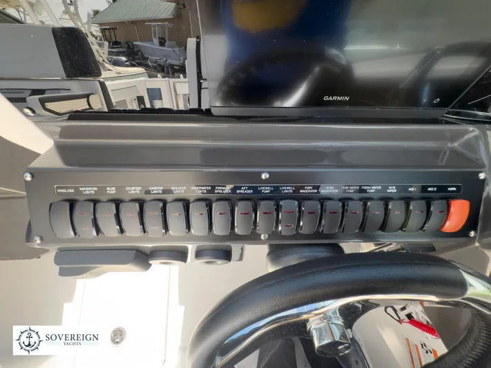  Yacht Photos Pics Control panel of a 2024 Blackfin 272 DC boat with various switches and Garmin display.