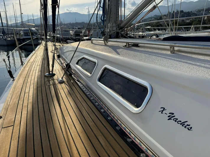  Yacht Photos Pics 2004 X-Yachts X 46 sailboat with teak deck, docked in a marina.
