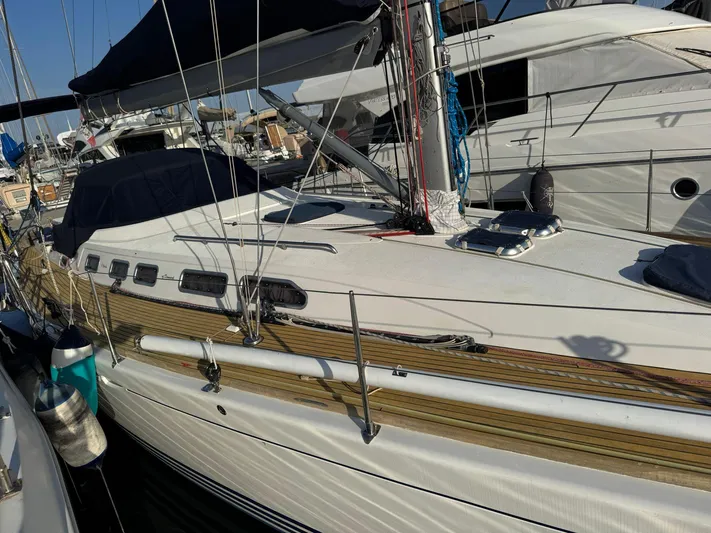  Yacht Photos Pics 2004 X-Yachts X 46 sailboat docked in marina, featuring sleek design and wooden deck.