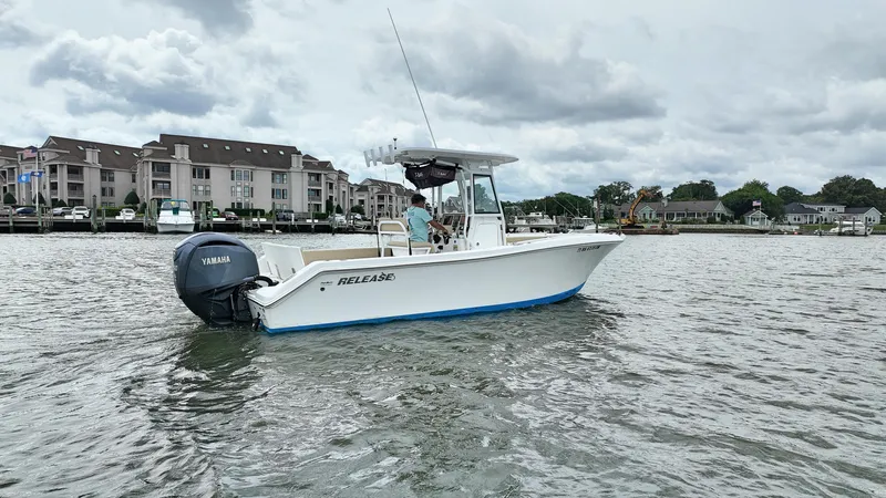  Yacht Photos Pics 2022 Release 240RX boat on water near residential area, overcast sky.