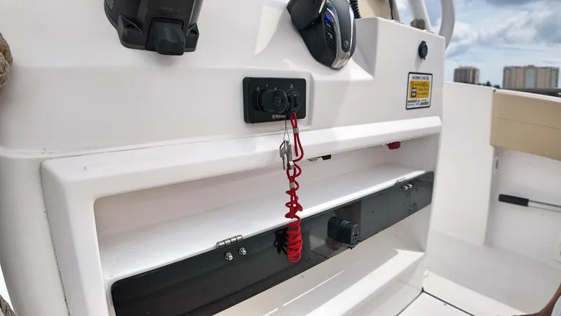  Yacht Photos Pics Control panel of a 2022 Release 240RX boat with safety features and cityscape background.