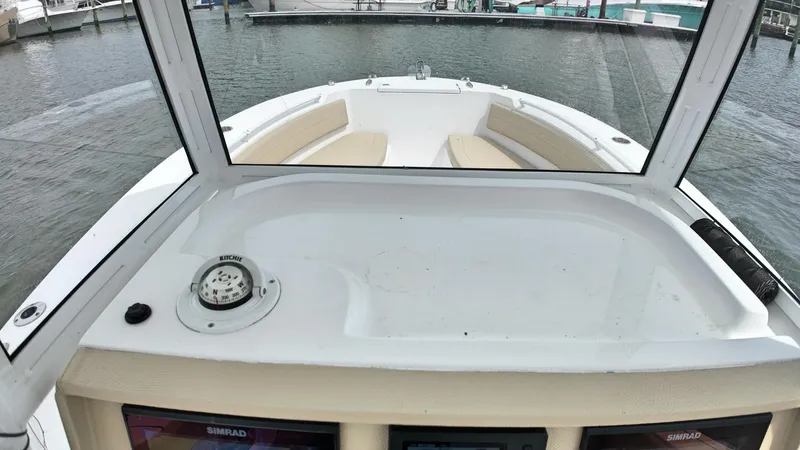  Yacht Photos Pics 2022 Release 240RX boat interior with compass, docked at marina.