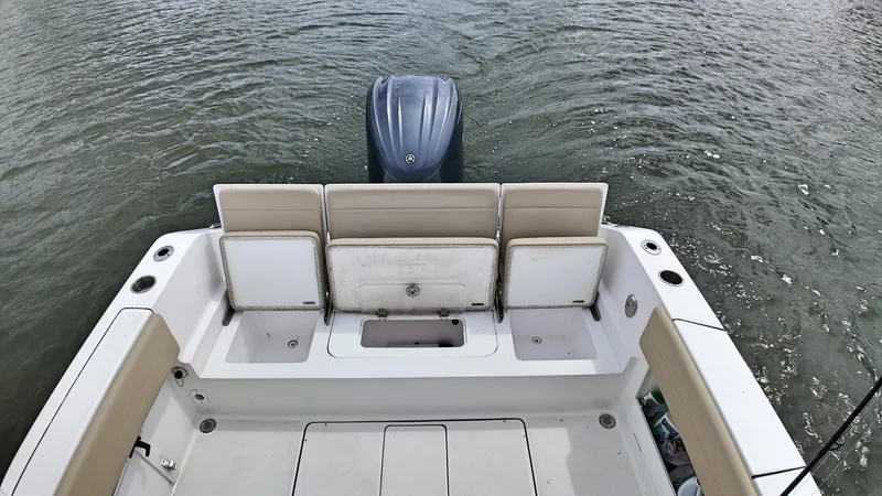  Yacht Photos Pics 2022 Release 240RX boat interior with seating and outboard motor on water.