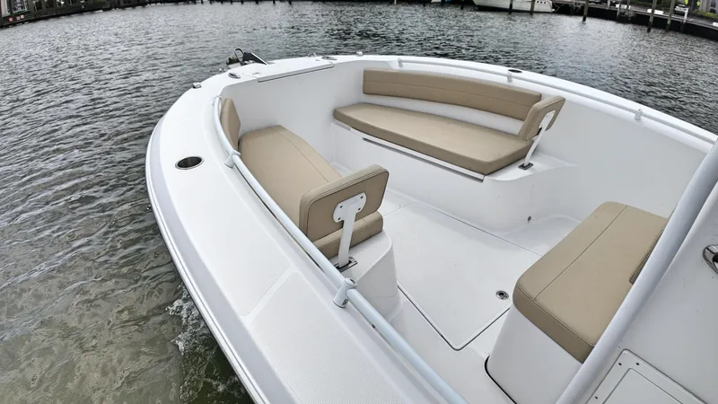  Yacht Photos Pics 2022 Release 240RX boat with beige seating on calm water.