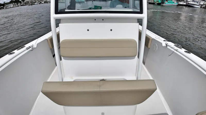  Yacht Photos Pics 2022 Release 240RX boat interior with beige seating, on calm water.
