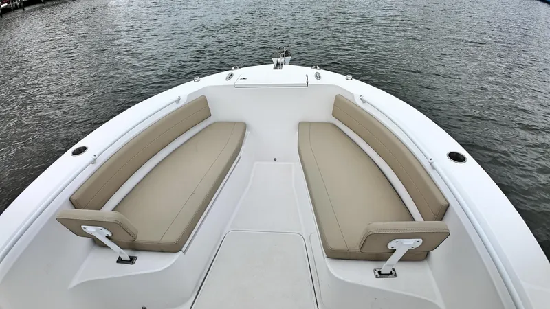  Yacht Photos Pics Bow seating area of 2022 Release 240RX boat with beige cushions on the water.
