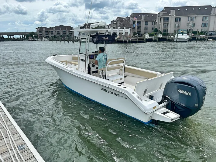  Yacht Photos Pics Boat on water, 2022 Release 240RX model, with Yamaha engine, near dock and waterfront buildings.